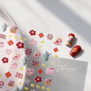 Detail of embossed Chinese New Year nail stickers with cartoon snake and floral motifs