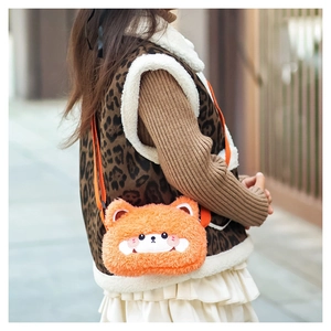Detail of soft orange plush crossbody bag with cute 3D ears and embroidered facial features