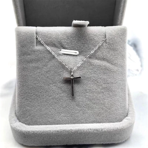 Minimalist S925 sterling silver cross pendant necklace displayed in a grey jewelry box