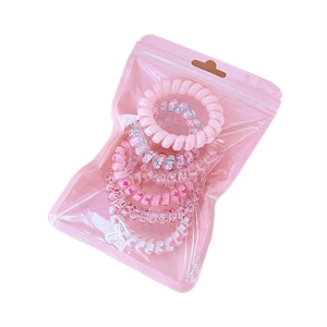 Pink gradient spiral telephone cord hair ties set in a translucent zipper bag packaging