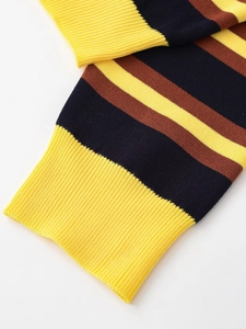 Close-up of striped knit sweater sleeve with yellow ribbed cuff and texture detail