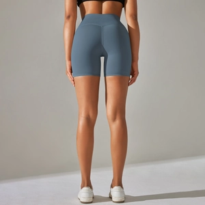 Detail view of high-waisted grey blue athletic shorts showing body-shaping fit and fabric