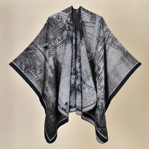 Women's knit poncho with black and white architectural pattern for travel and camping