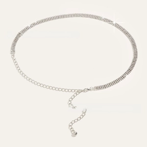 Detailed macro view of triple-row rhinestone waist chain with adjustable silver extender link