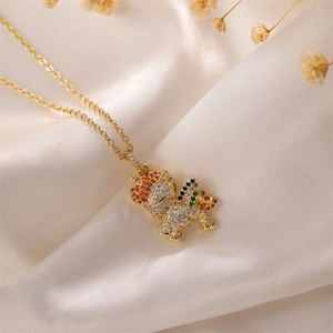 Macro shot of gold plated unicorn pendant with colorful cubic zirconia on silk