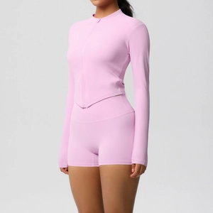 Detail view of pink sports set featuring slim-fit zipper jacket and high-waisted shorts