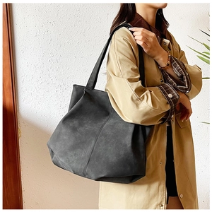 Close-up of charcoal gray tote bag with matte texture and vertical stitching detail