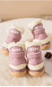 Close-up of pink winter dog boots with warm fleece lining and non-slip rubber soles