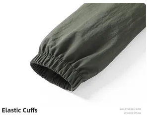 Close-up of elastic cuffs on a dark green outdoor jacket showing detailed stitching