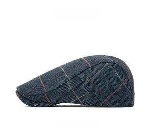 Close-up of blue-grey herringbone flat cap with orange and yellow windowpane checks