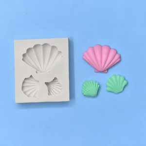 White silicone seashell mold with three cavities and colorful decorative finished pieces