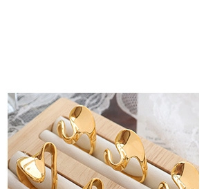 Detailed view of irregular wavy 18K gold plated earrings with a polished mirror finish