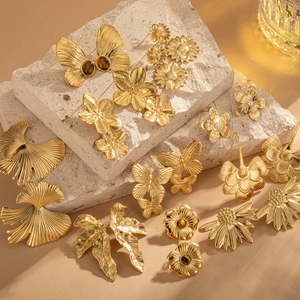 Macro detail of vintage 18k gold butterfly earrings with natural tiger eye stones
