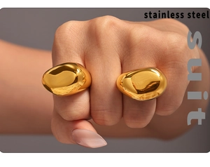 Detail of chunky gold irregular pebble rings in polished stainless steel on hand