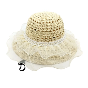Women's beige straw sun hat with lace wavy brim and pearl accents on white background