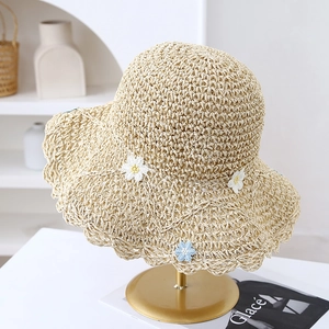 Handmade straw sun hat with daisy embroidery and wavy brim for summer beach vacation