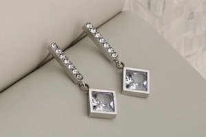 Macro shot of silver drop earrings with square clear zircon and pavé bar detailing