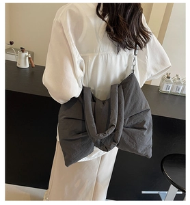 Detail of oversized dark grey nylon bow tote bag showing charcoal finish and large capacity
