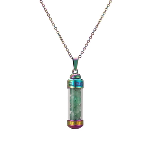 Macro shot of rainbow-plated wish bottle pendant with green stone chips inside
