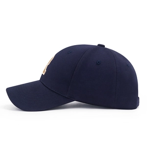 Navy blue baseball cap with gold 3D embroidery on a solid white background