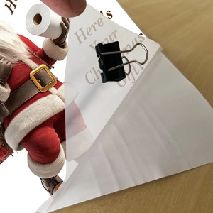 Détail du sticker Père Noël pour toilettes avec texte Here's Your Christmas Gift et papier
