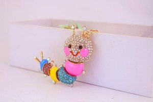 Close-up of a colorful caterpillar keychain with vibrant rhinestones and gold plating