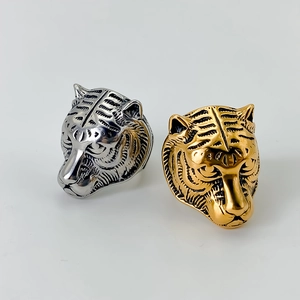 Men's bold stainless steel tiger head rings in polished gold and silver finishes
