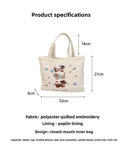 Detail view of cute embroidered dachshund dogs and colorful bows on a quilted tote bag