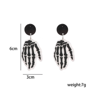 Detail view of cartoon skull hand earrings with 6cm length and 3cm width measurements