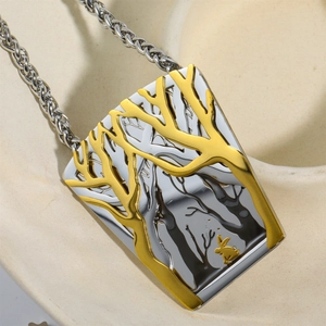 Vintage stainless steel necklace featuring a gold rabbit and tree pendant on silver