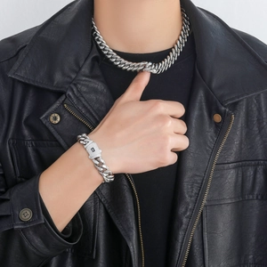 Close-up of polished silver Cuban chain with a diamond-encrusted clasp and spring buckle
