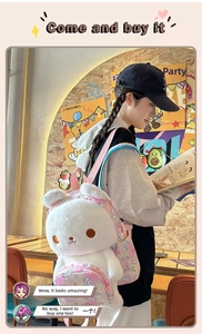 Detail of cute white plush rabbit backpack featuring pink floral straps on a model
