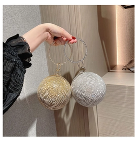 Detail of gold and silver rhinestone sphere evening bags with sparkly ring handles
