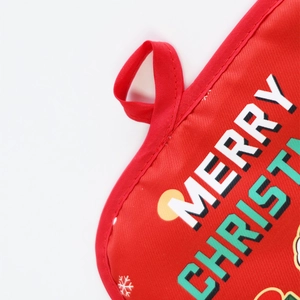 Close-up detail of red Christmas kitchen oven mitt with hanging loop and festive printed text.