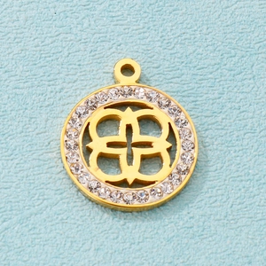 Macro shot of gold-plated hollow clover pendant with sparkling rhinestones on blue background