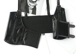 Detail view of black punk style leather corset belt with adjustable buckles and straps