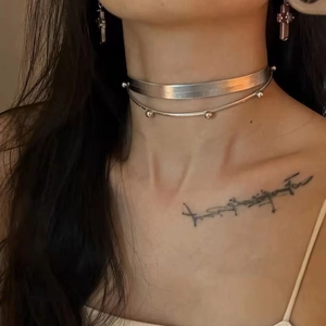 Detail of silver double-layered Y2K choker with metal beads on wide flat band