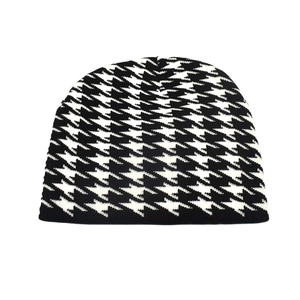 Detailed view of black and white houndstooth pattern on a warm winter knitted beanie
