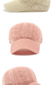 Detail of knitted cable knit baseball cap with subtle sequins in beige and pink tones