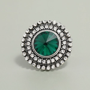 Top view of bohemian round ring with large green gem and white rhinestones in silver finish
