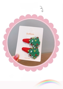 Detail of handmade Christmas tree hair clips with green sequins and colorful ornaments