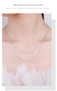 Detail of 925 sterling silver double-layered paperclip chain necklace on model neck