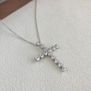 Close-up of S925 sterling silver cross necklace with pear-cut zircon stone settings