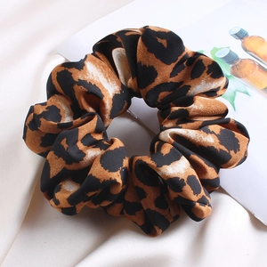 Detailed macro view of the leopard print satin hair scrunchie with silk-like texture