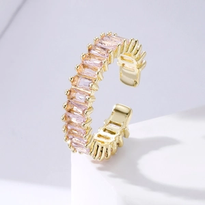 Detailed close-up of a gold C-shape ring featuring pink rectangular cut cubic zirconia stones