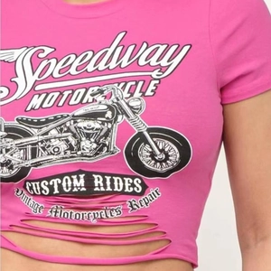 Detail of pink crop top with vintage motorcycle print and distressed hollow out design