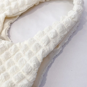 Minimalist white popcorn fabric cloud shoulder bag with detailed puff texture and seams