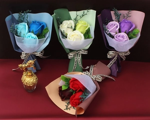 Detail view of four soap rose bouquets in blue, green, purple, and red hues with mesh wrap