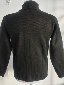 Back view of a black high-neck knit sweater showing fit and thick textured fabric