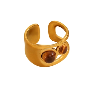 Modern gold open ring with irregular hollow design and polished brown tiger eye stones